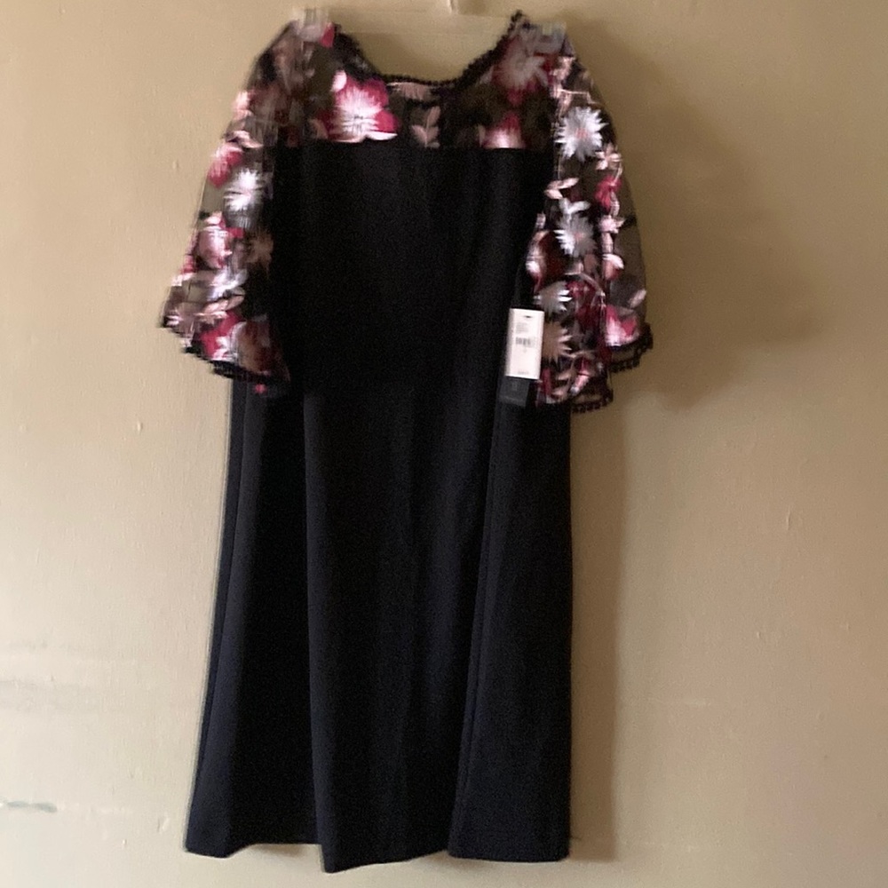 Black dress with multi colored on top and sleeves.